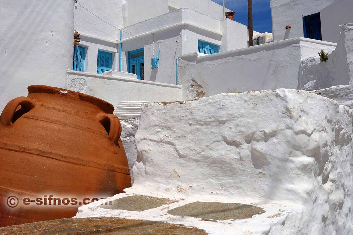 Bright white houses with light blue windows in Artemonas