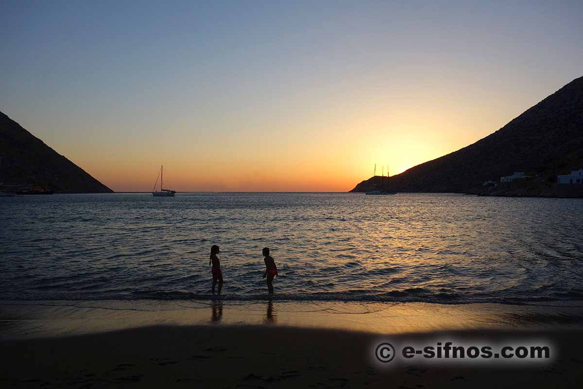 Children playing at the beach at the sunset